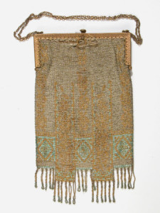 Hand bag - Rectangular beaded hand bag (evening) in silver gold and green small glass beads. Twisted bead fringe. Gilt frame and chain. Label inside brown sateen lining 'Jean Lindsay, 22 Nanking Road, Shanghai'. 1920 (circa)